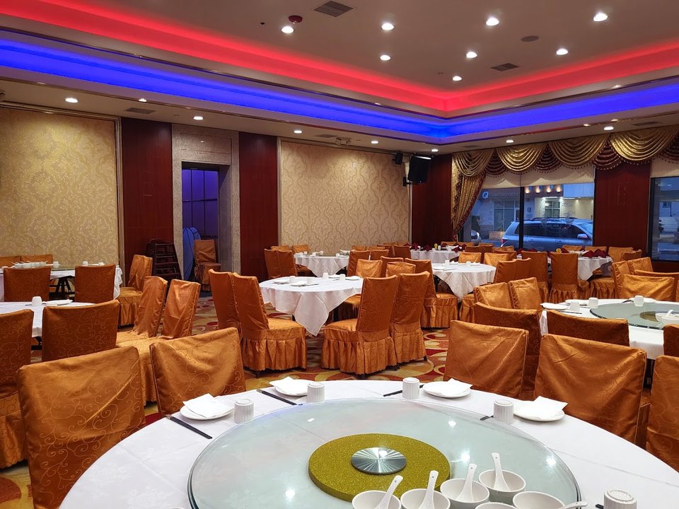 Dim sum plates on round restaurant tables.